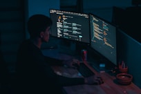 man in black long sleeve shirt using computer
