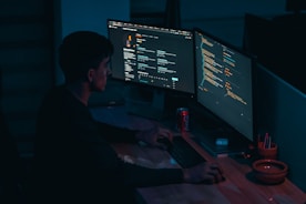 man in black long sleeve shirt using computer