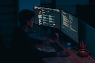 man in black long sleeve shirt using computer