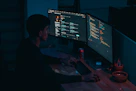 man in black long sleeve shirt using computer