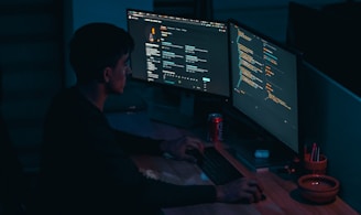 man in black long sleeve shirt using computer