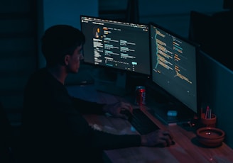 man in black long sleeve shirt using computer