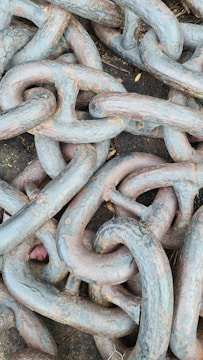 Close-up of heavy-duty transport chains secured on a flatbed truck.