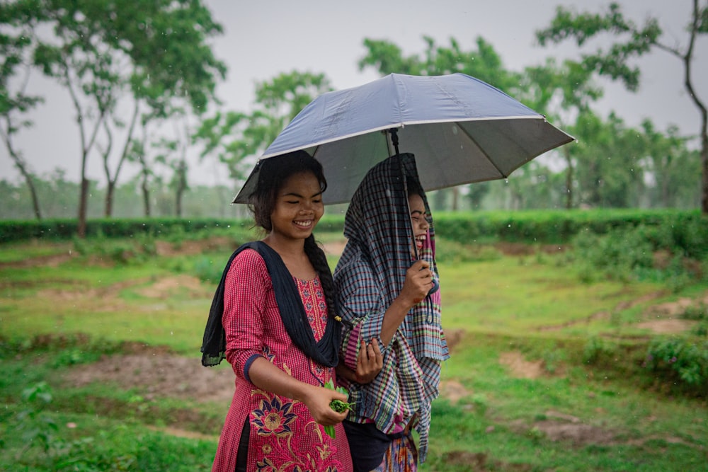 woman in red and blue dress holding umbrella