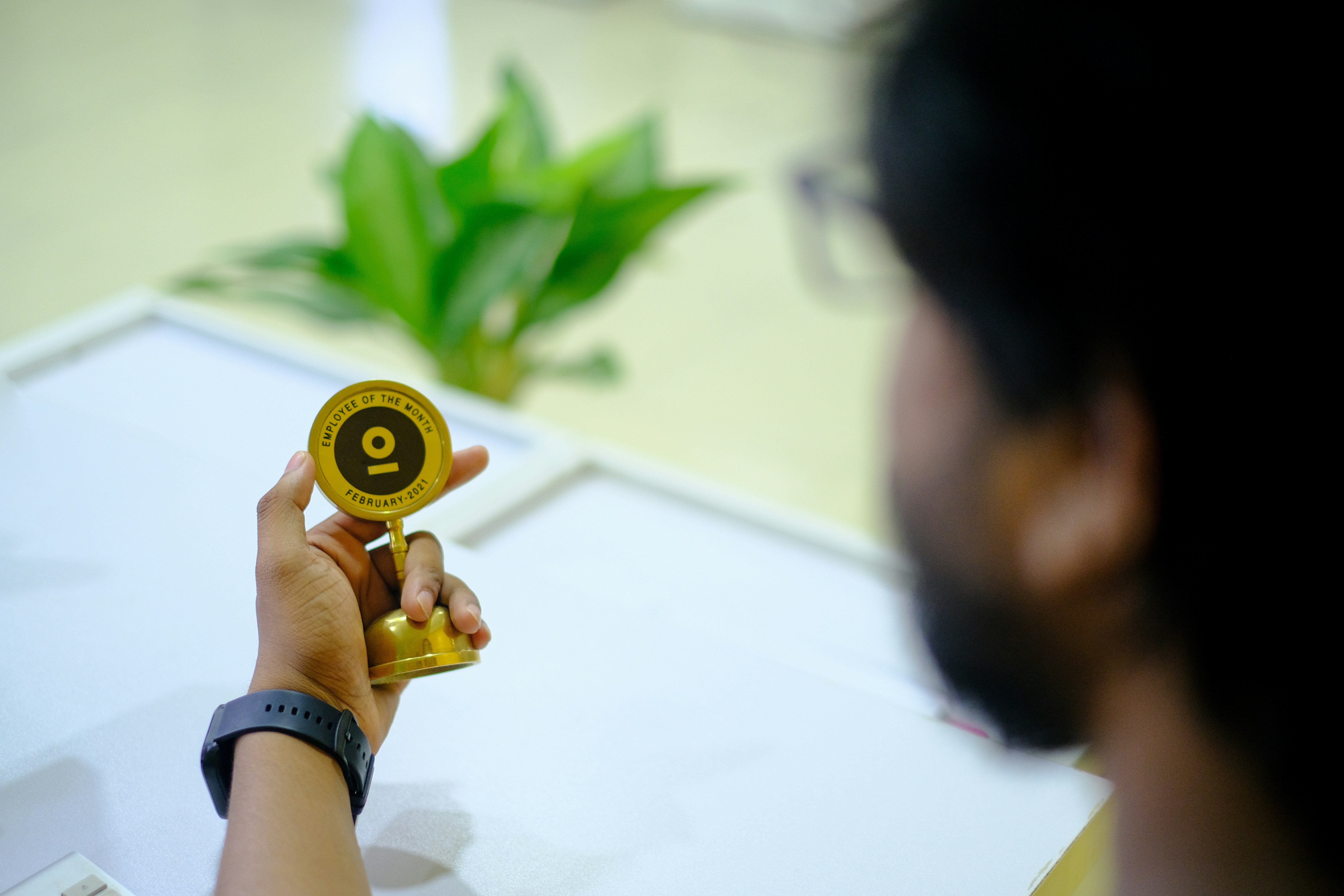 person holding round brown and white ornament