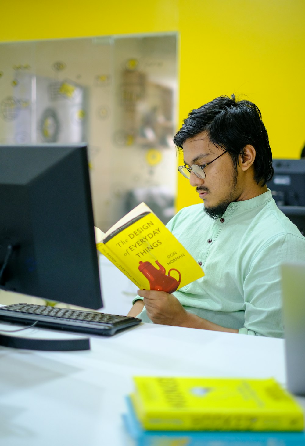 man in white dress shirt holding yellow box