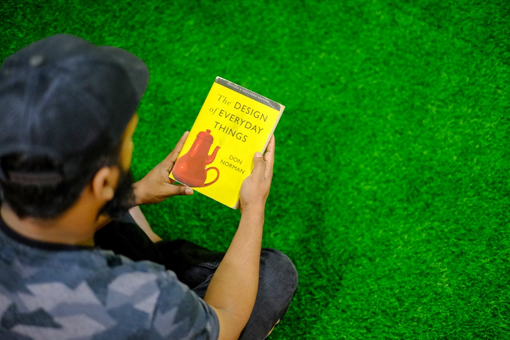 person holding yellow and white labeled box