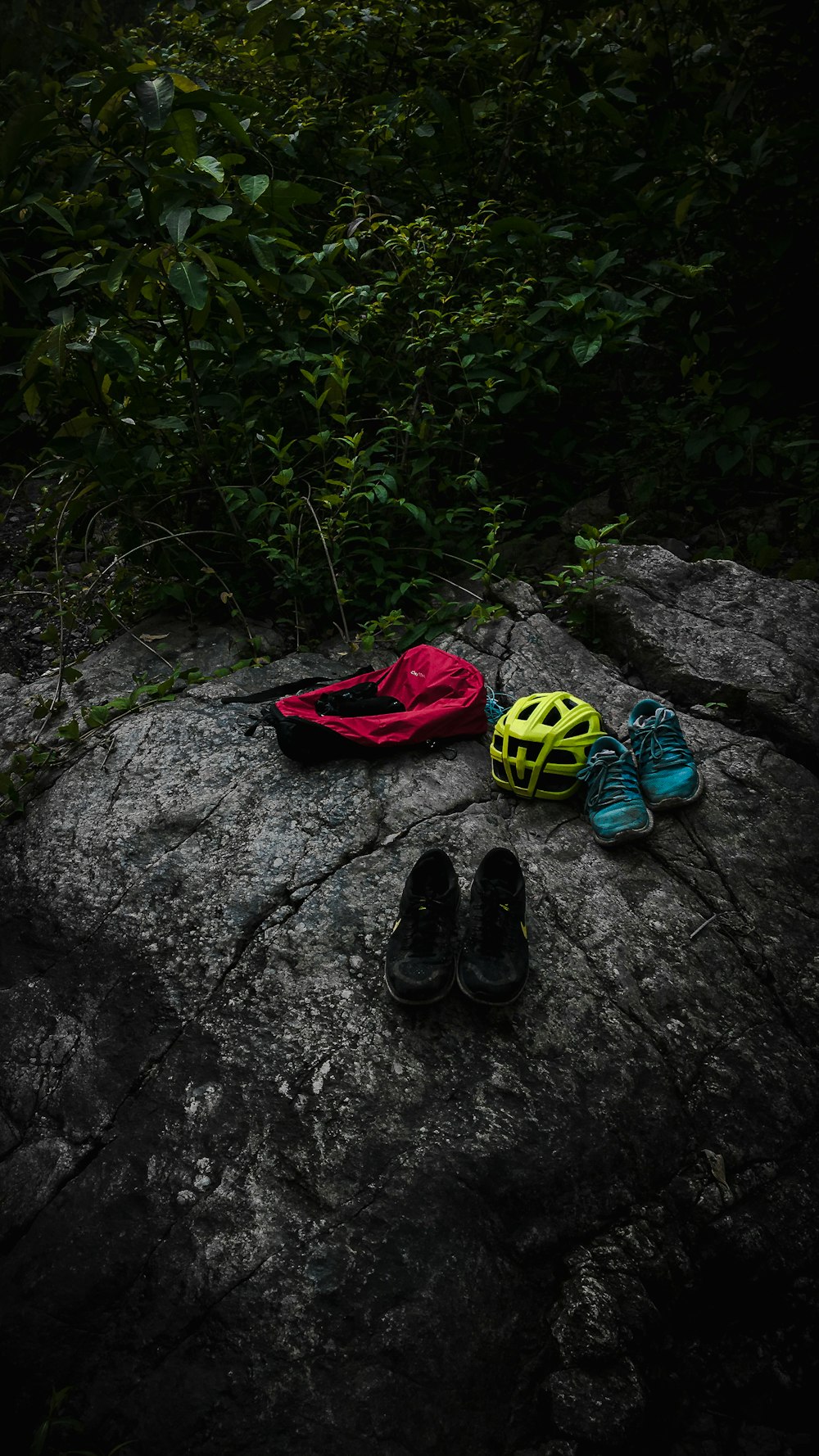 black and blue sneakers on gray rock