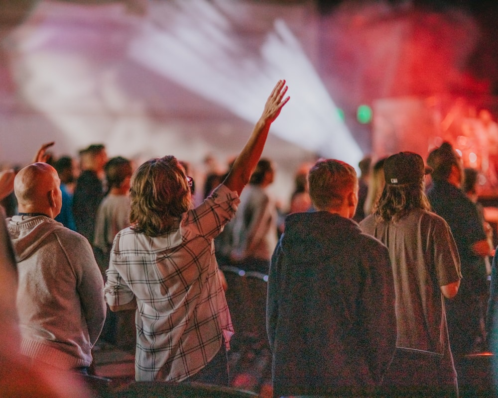 a group of people standing in front of a stage