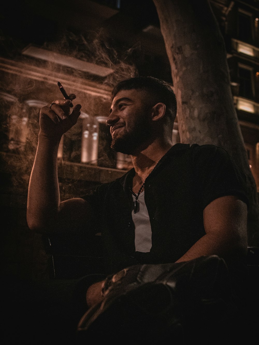 Man in black vest smoking cigarette photo – Free Baku Image on Unsplash
