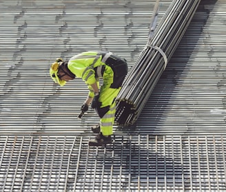 a construction worker working on a metal grate