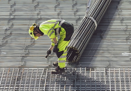 a construction worker working on a metal grate