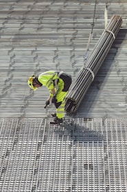 a construction worker working on a metal grate