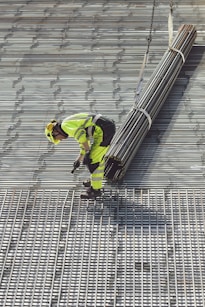 a construction worker working on a metal grate