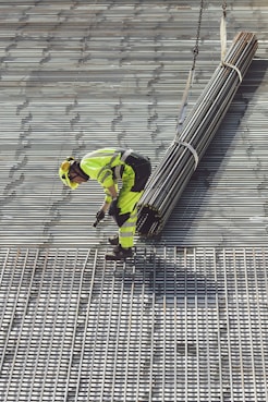 a construction worker working on a metal grate
