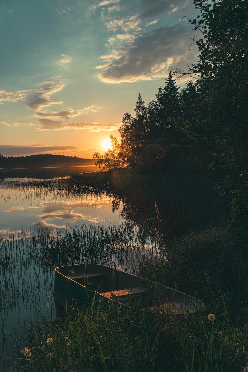 a small boat sitting on top of a lake