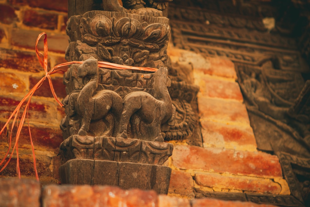 a statue of elephants on a brick wall