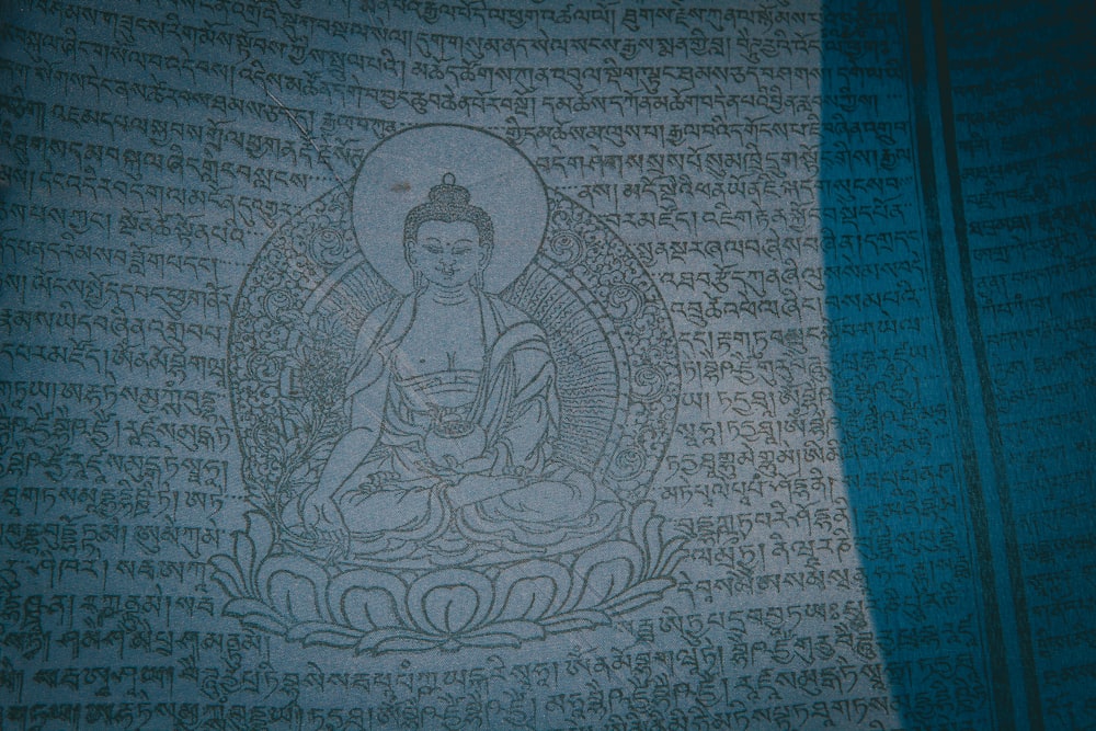 a picture of a buddha statue on a wall