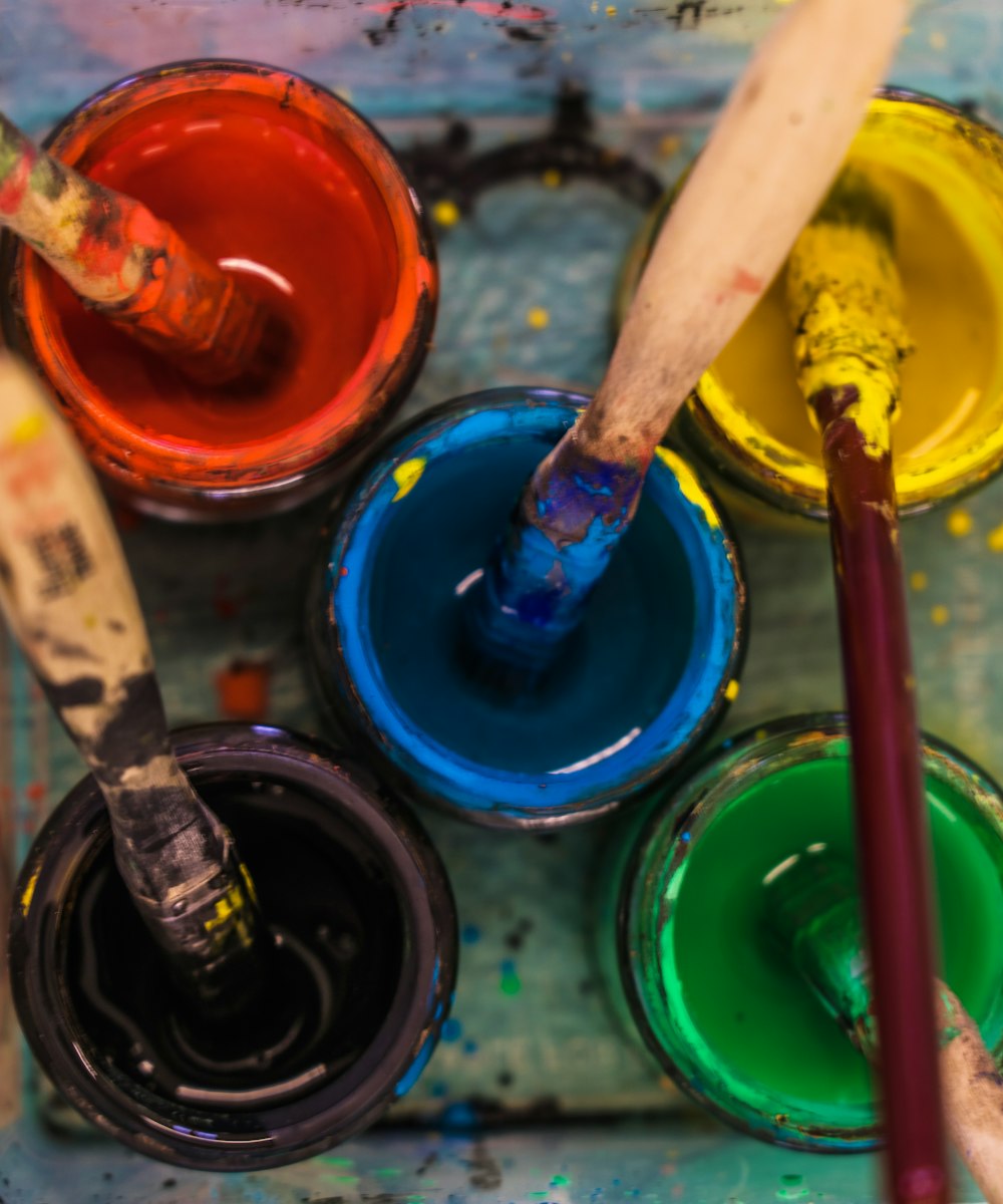 a close up of paint and brushes on a tray