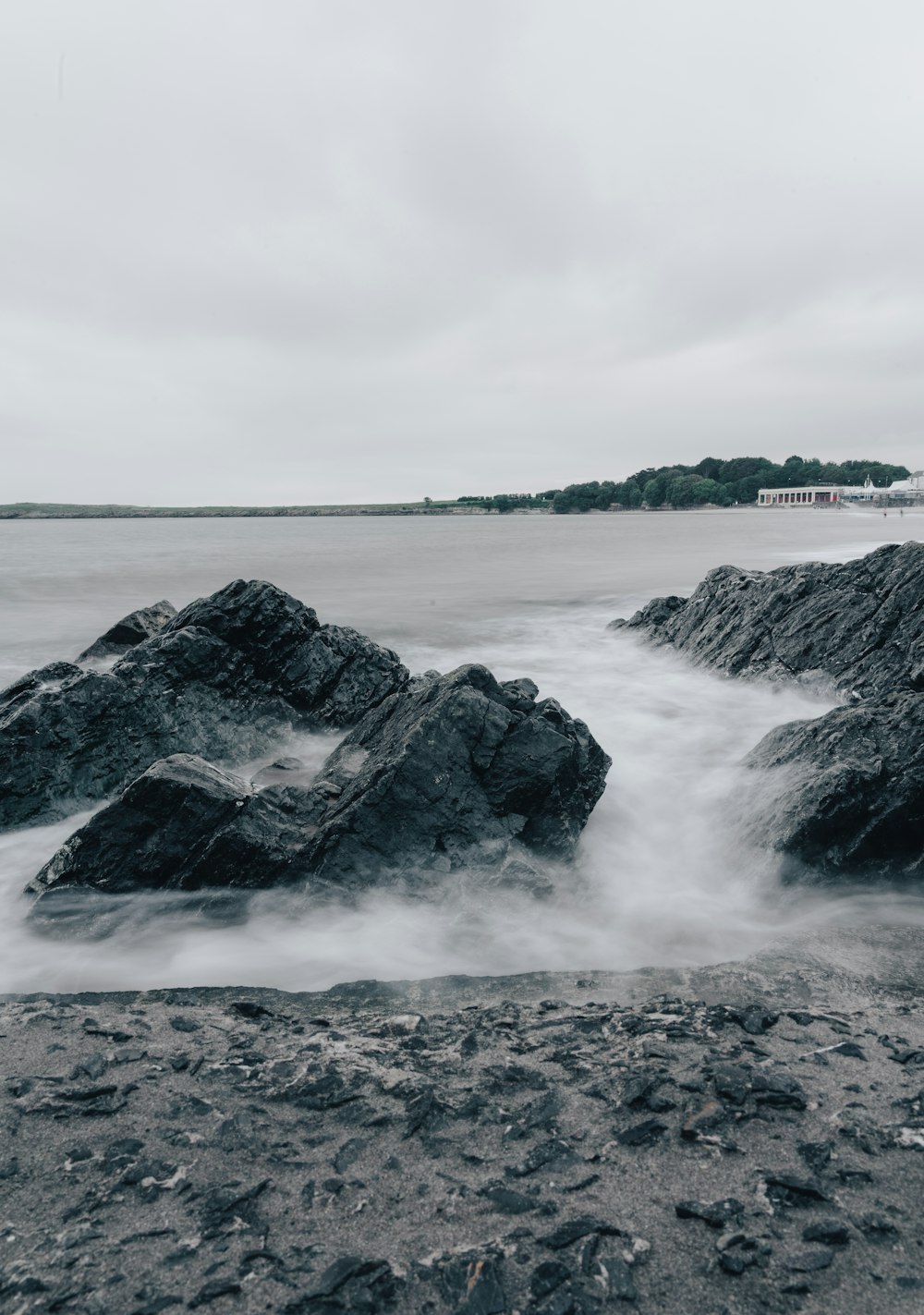 a black and white photo of rocks in the water