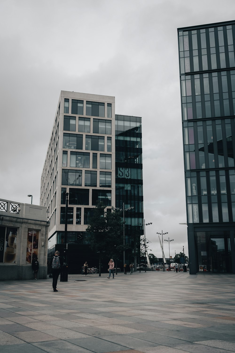 a couple of tall buildings sitting next to each other