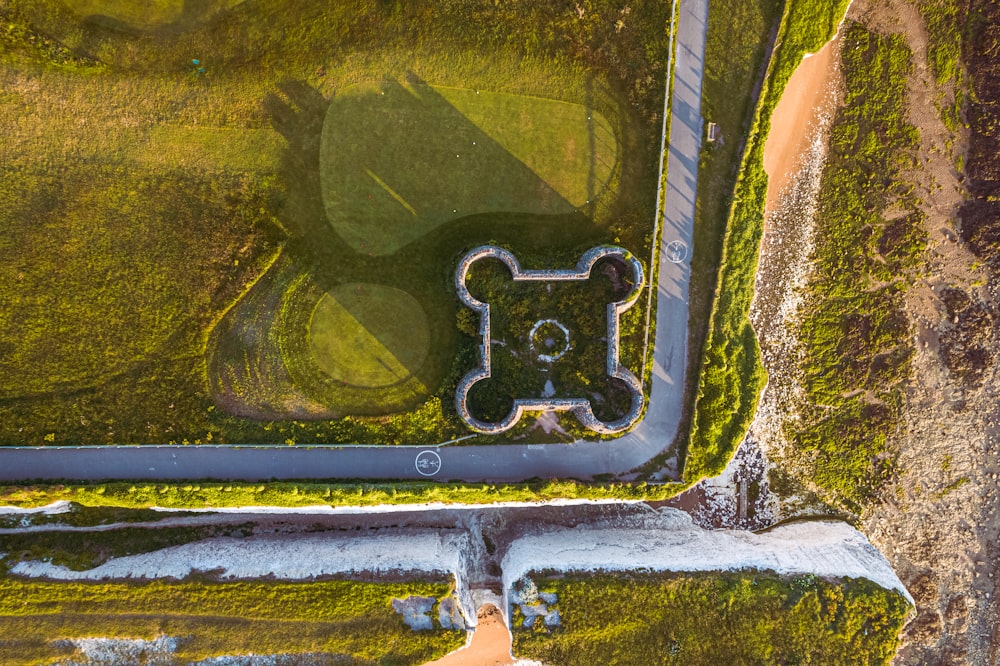 an aerial view of a road and a grassy field