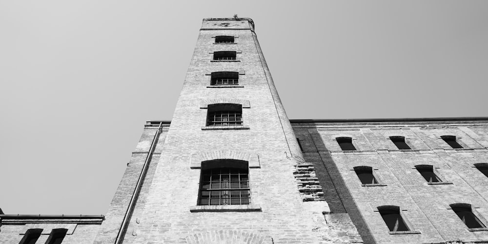 gray concrete building with red and black windows