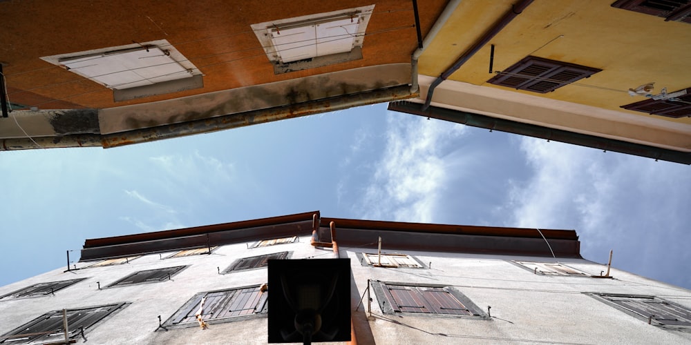 white and brown concrete building under white clouds during daytime