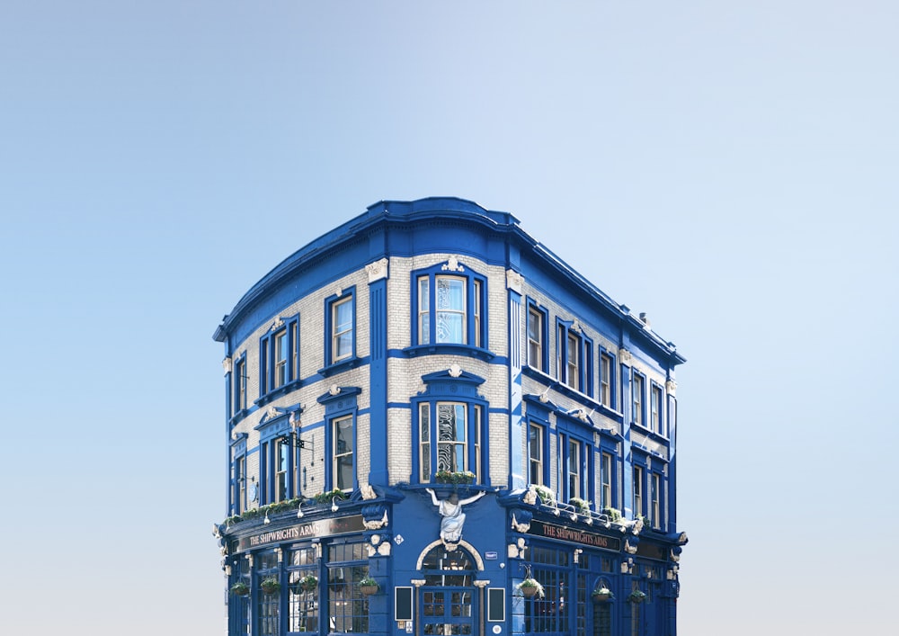 a blue and white building on a street corner