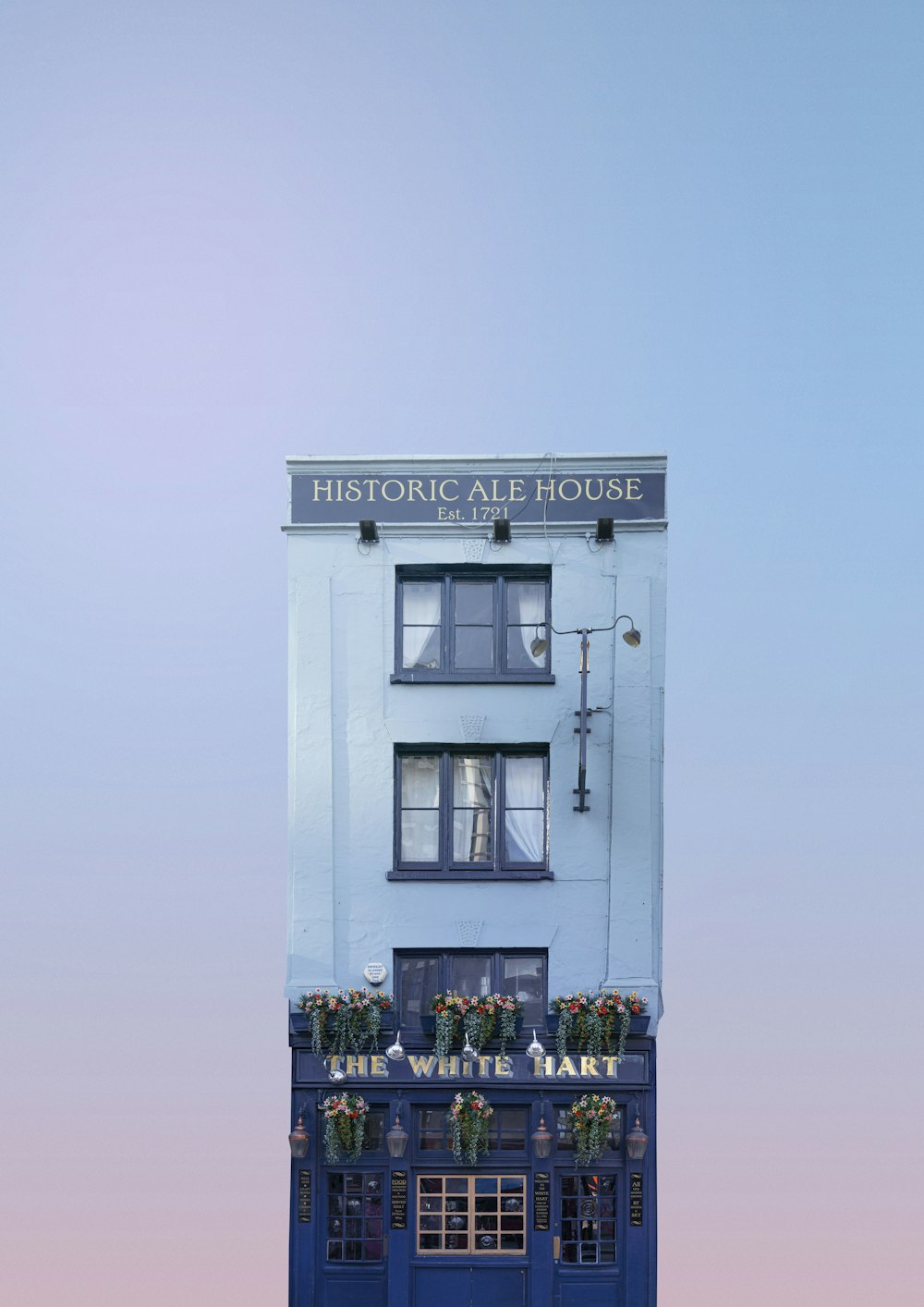 a tall white building with a blue door