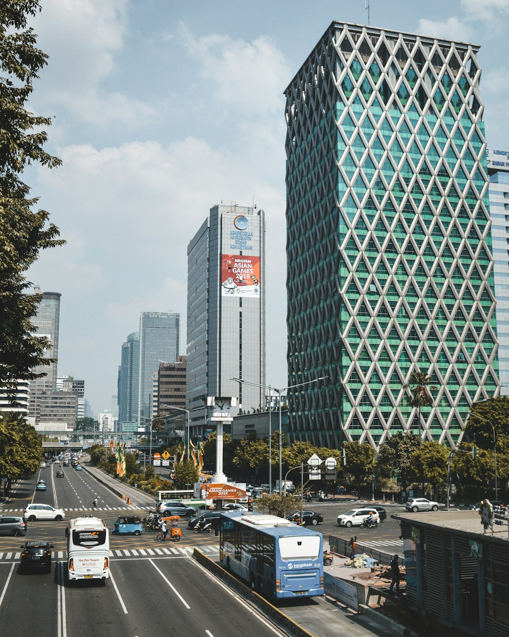 cars parked on parking lot near high rise buildings during daytime