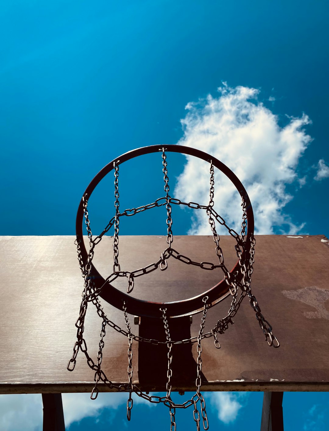 brown metal swing under blue sky during daytime