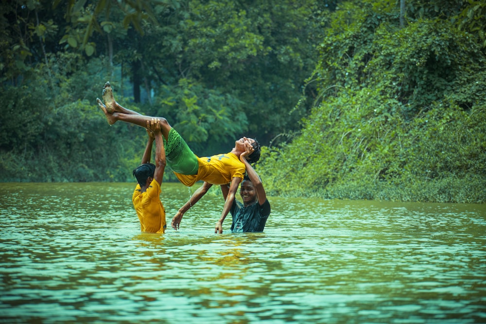 2 men in blue shorts on water during daytime