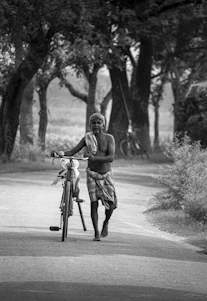 A serene, minimalist silhouette of an elderly man standing barefoot on a sunlit path, embodying freedom and simplicity.