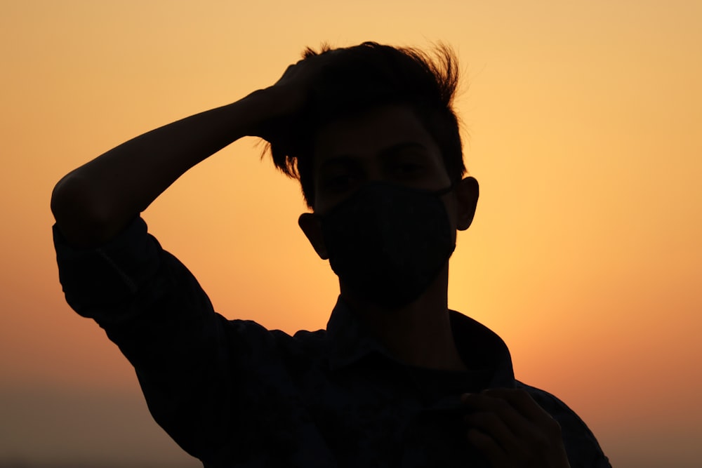 silhouette of woman raising her right hand