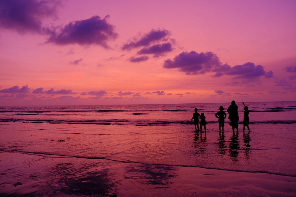 silhouette of people on beach during sunset