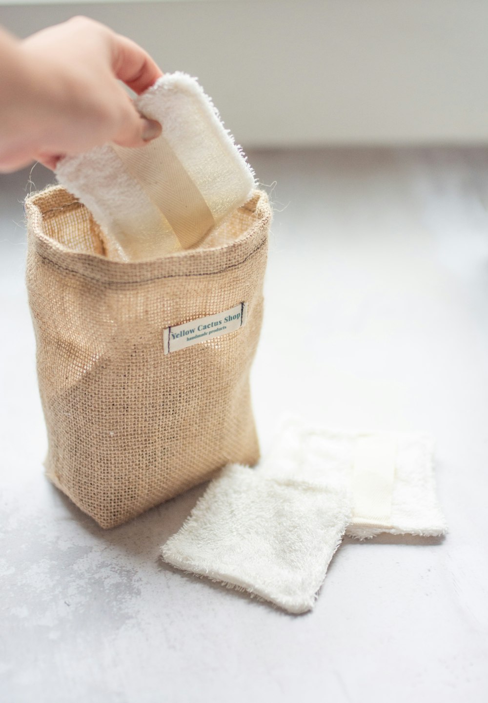 a person putting a cloth in a bag