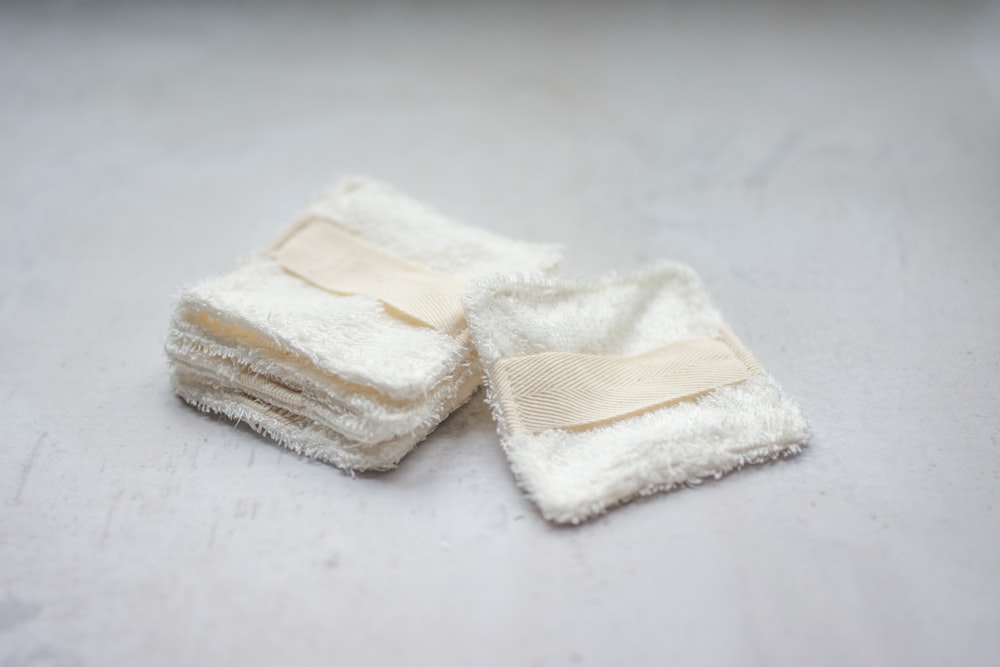 a pile of white towels sitting on top of a table