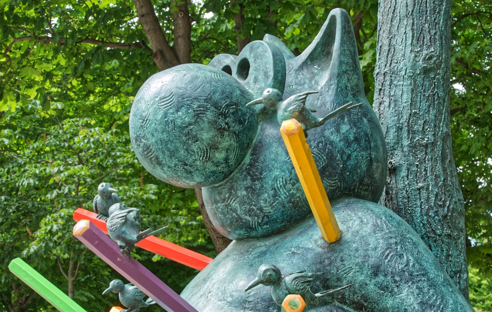 yellow and red stick on gray concrete statue