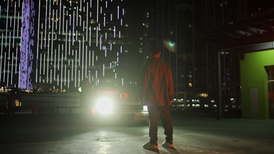 A professional agent inspecting a used car in a bright urban setting.