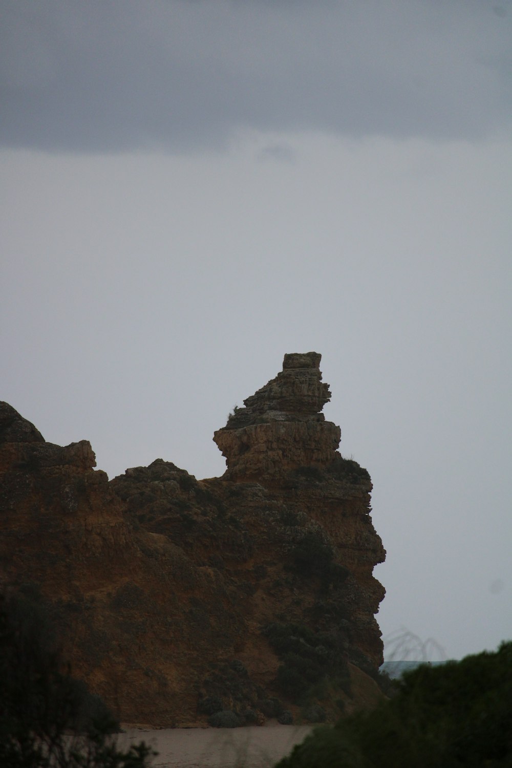 brown rock formation under white sky during daytime