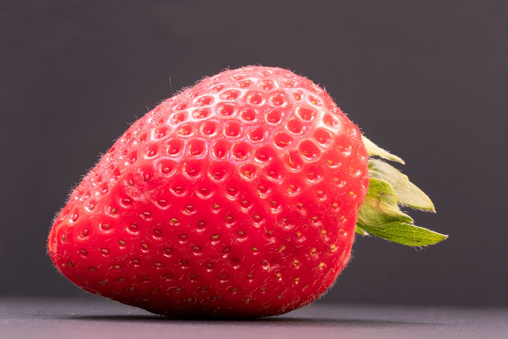 red strawberry fruit on white table