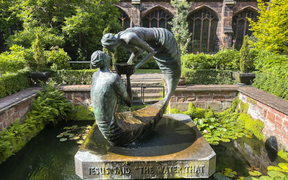 gray concrete statue of man on water fountain