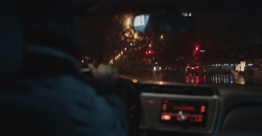 a view of a city street at night from inside a car