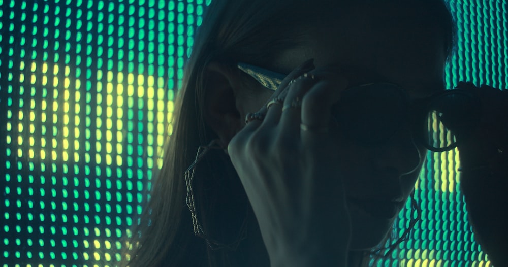 a woman holding a cell phone up to her face