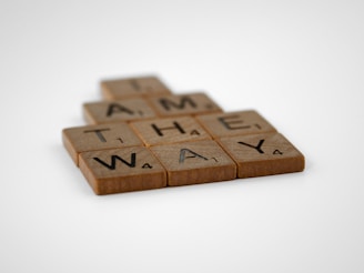 a scrabble tile with the words game the way on it