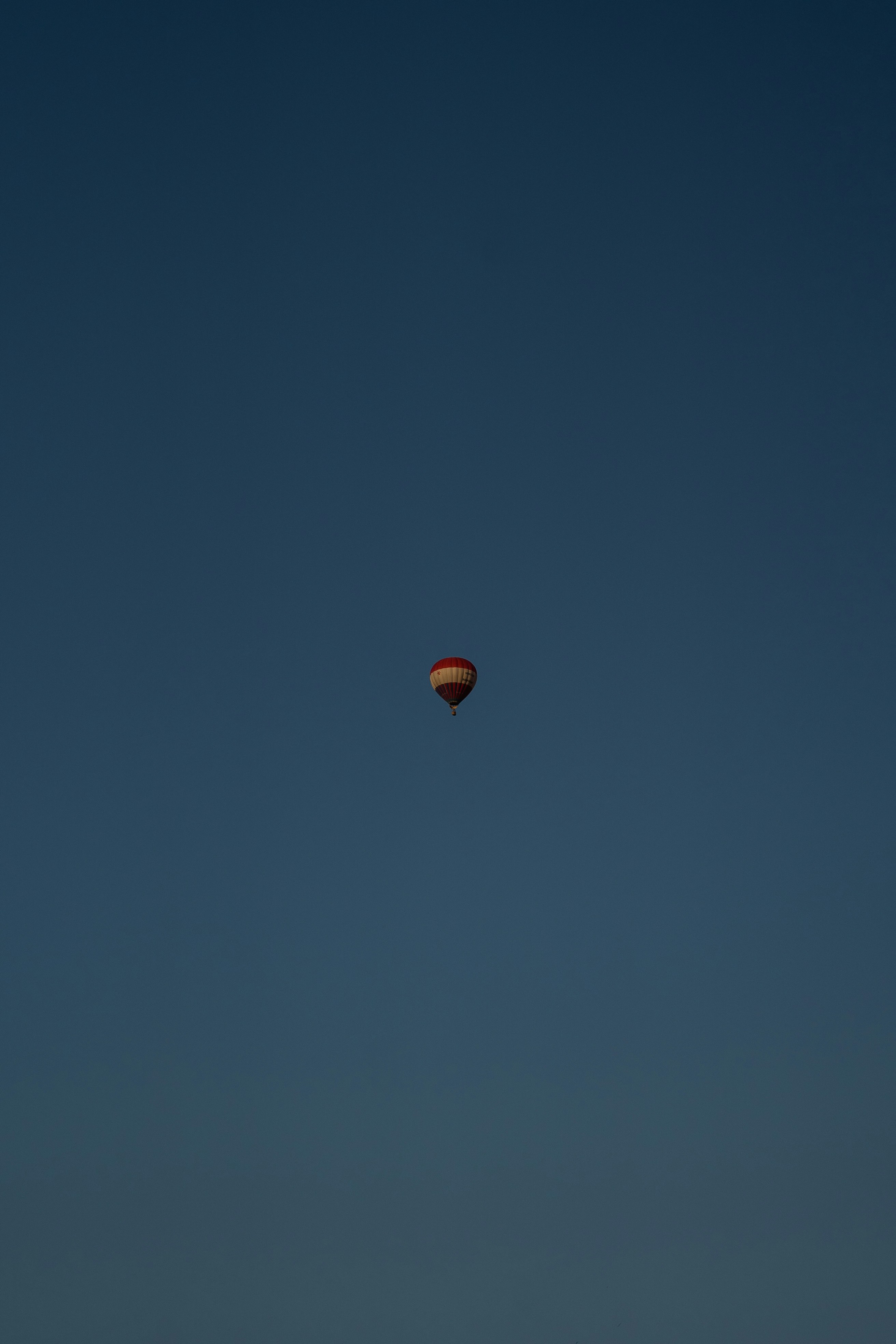 red and black hot air balloon in the sky