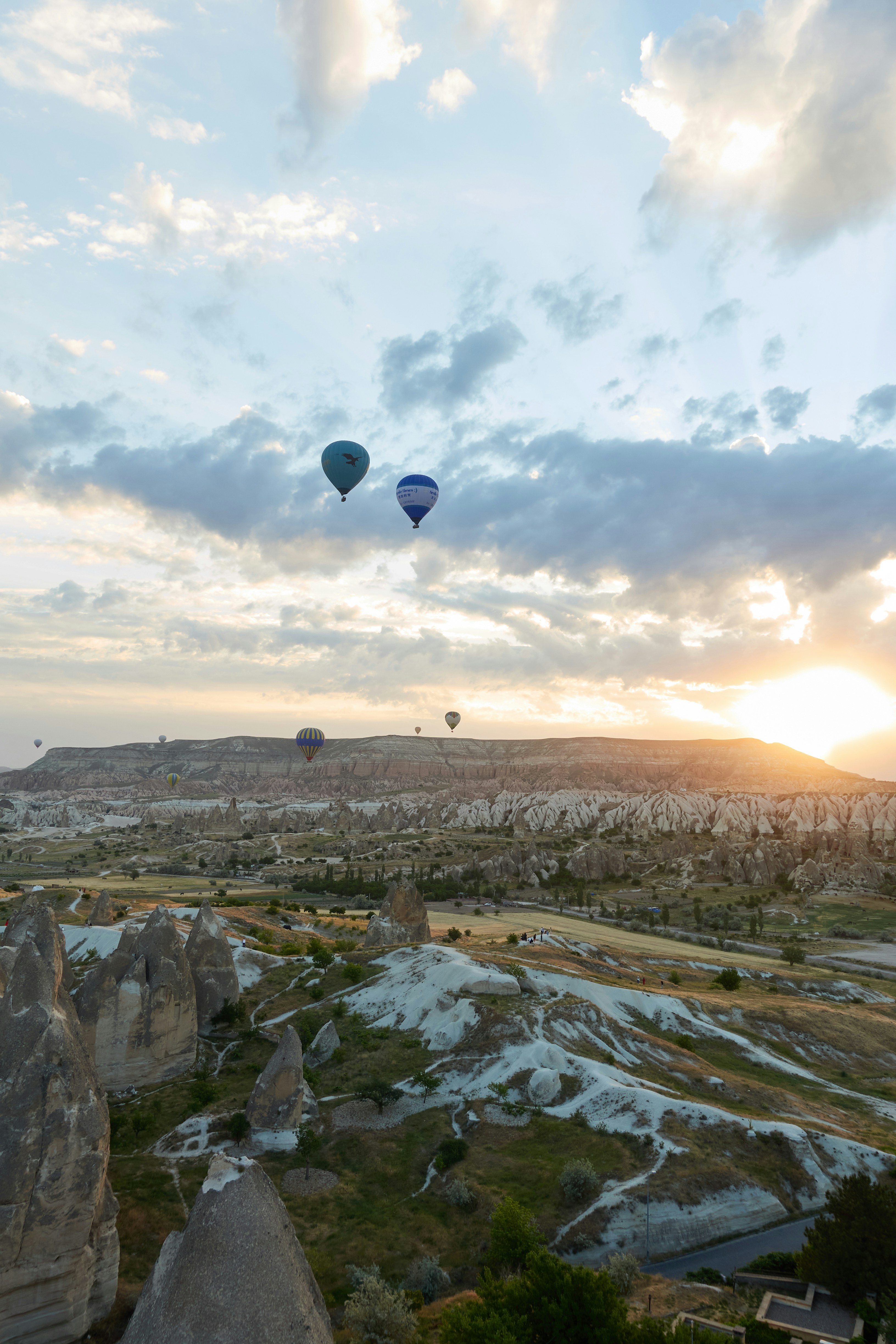hot air balloons flying over the city during daytime
