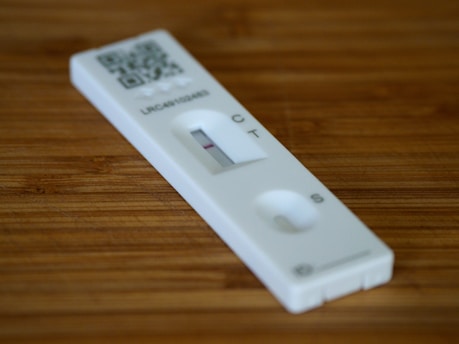 a remote control sitting on top of a wooden table