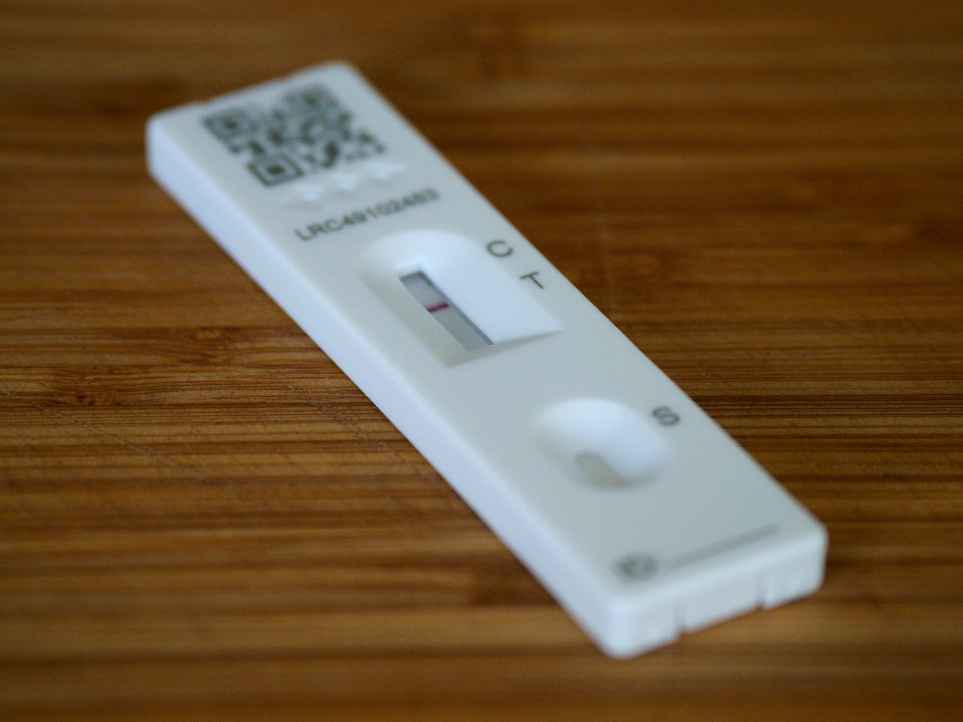 a remote control sitting on top of a wooden table